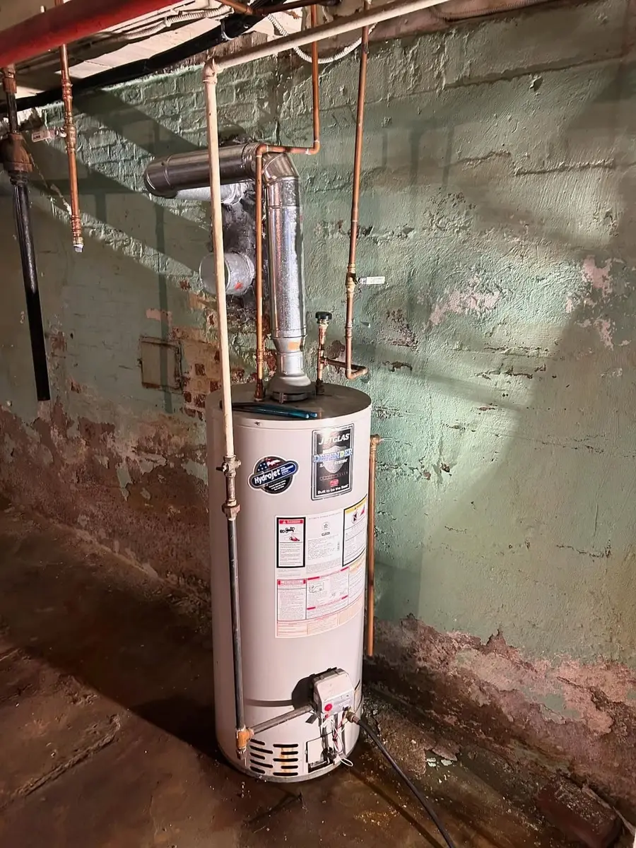 Old water heater in a basement before replacement