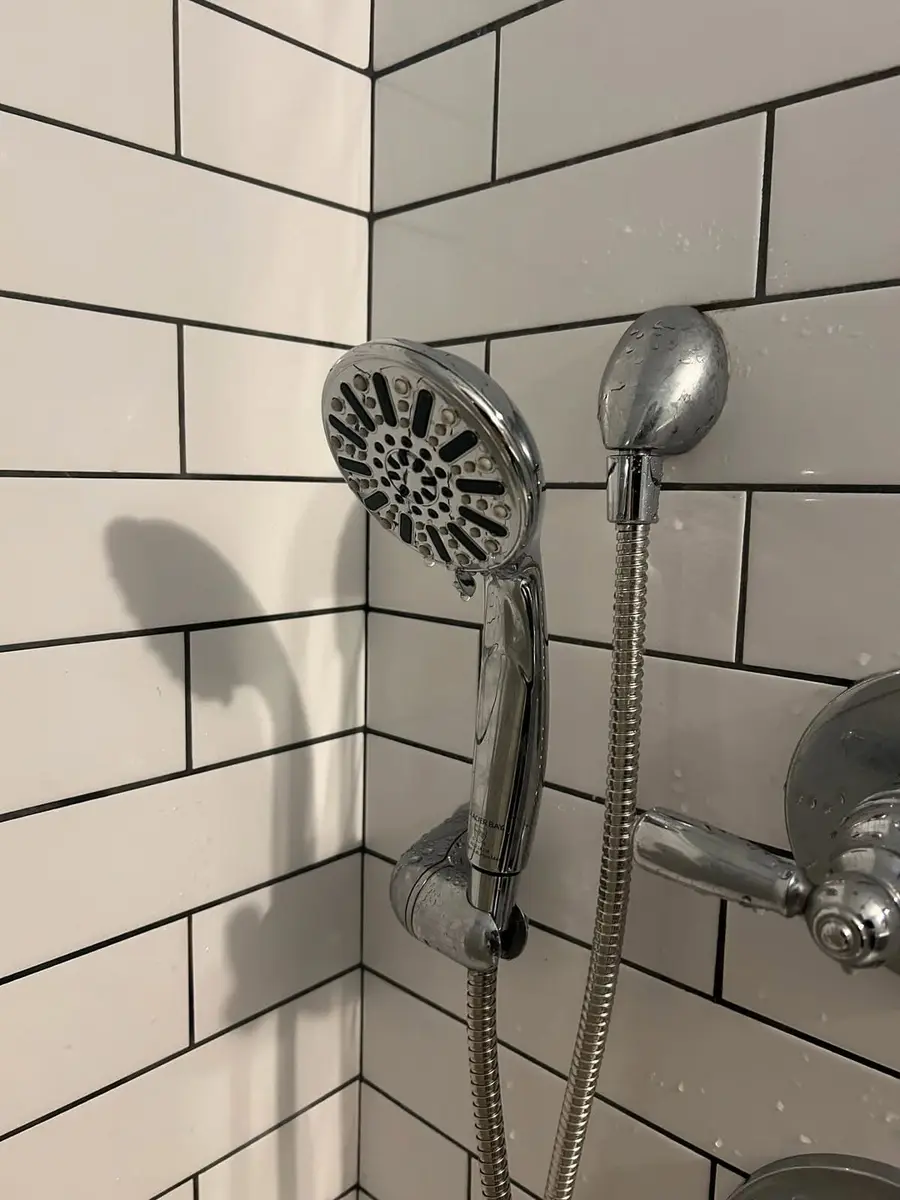 New shower head and hand shower on tile