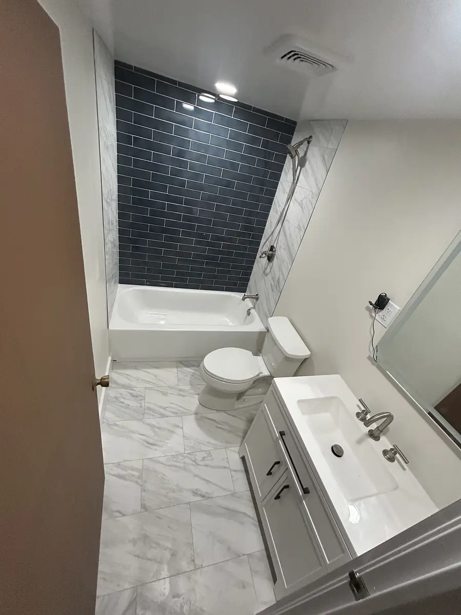 Black Tile Bath by S. Meredith Plumbing & Heating