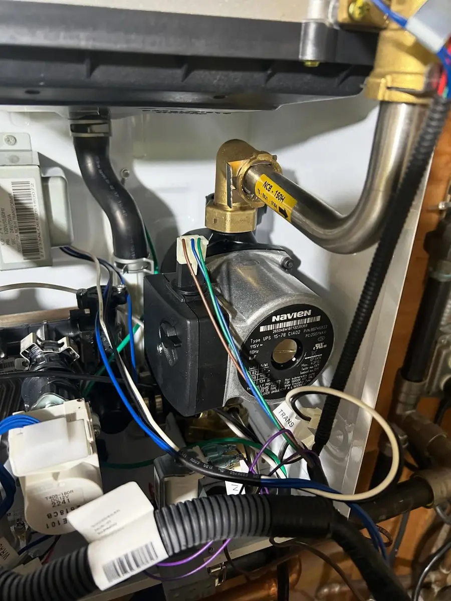 Inside the Navien combi boiler during the repair
