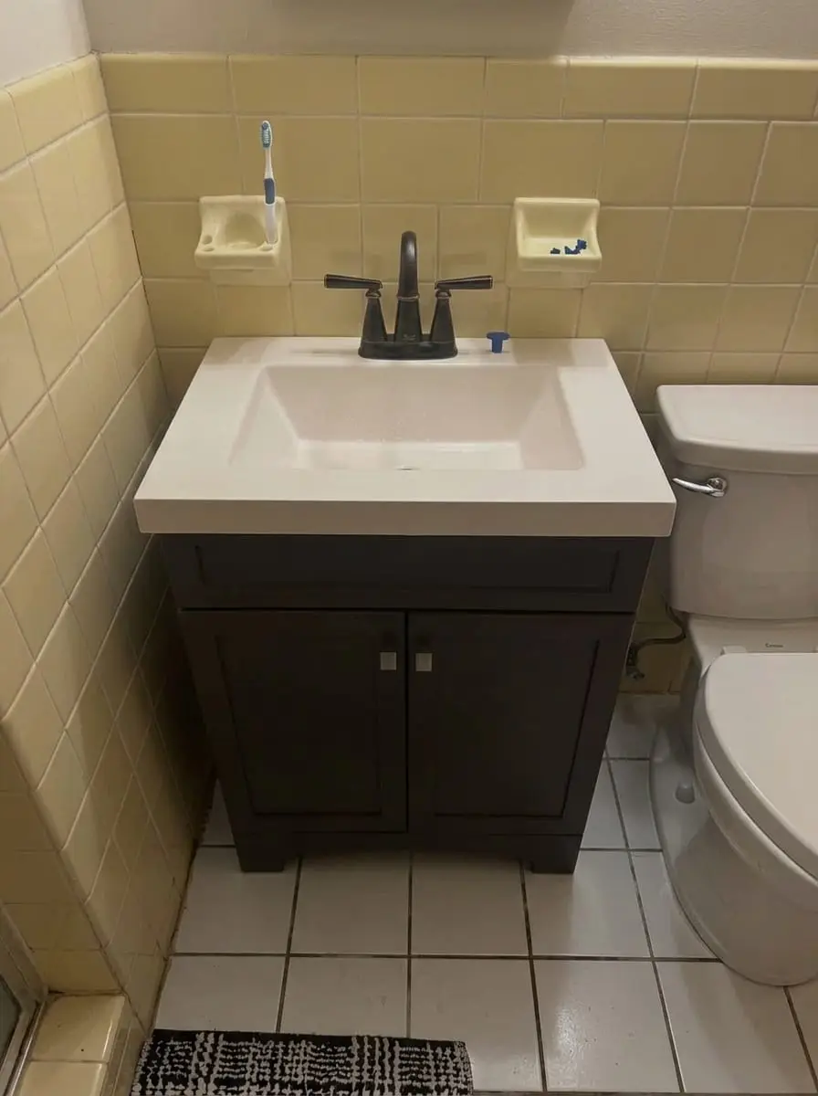 New dark vanity with a black faucet