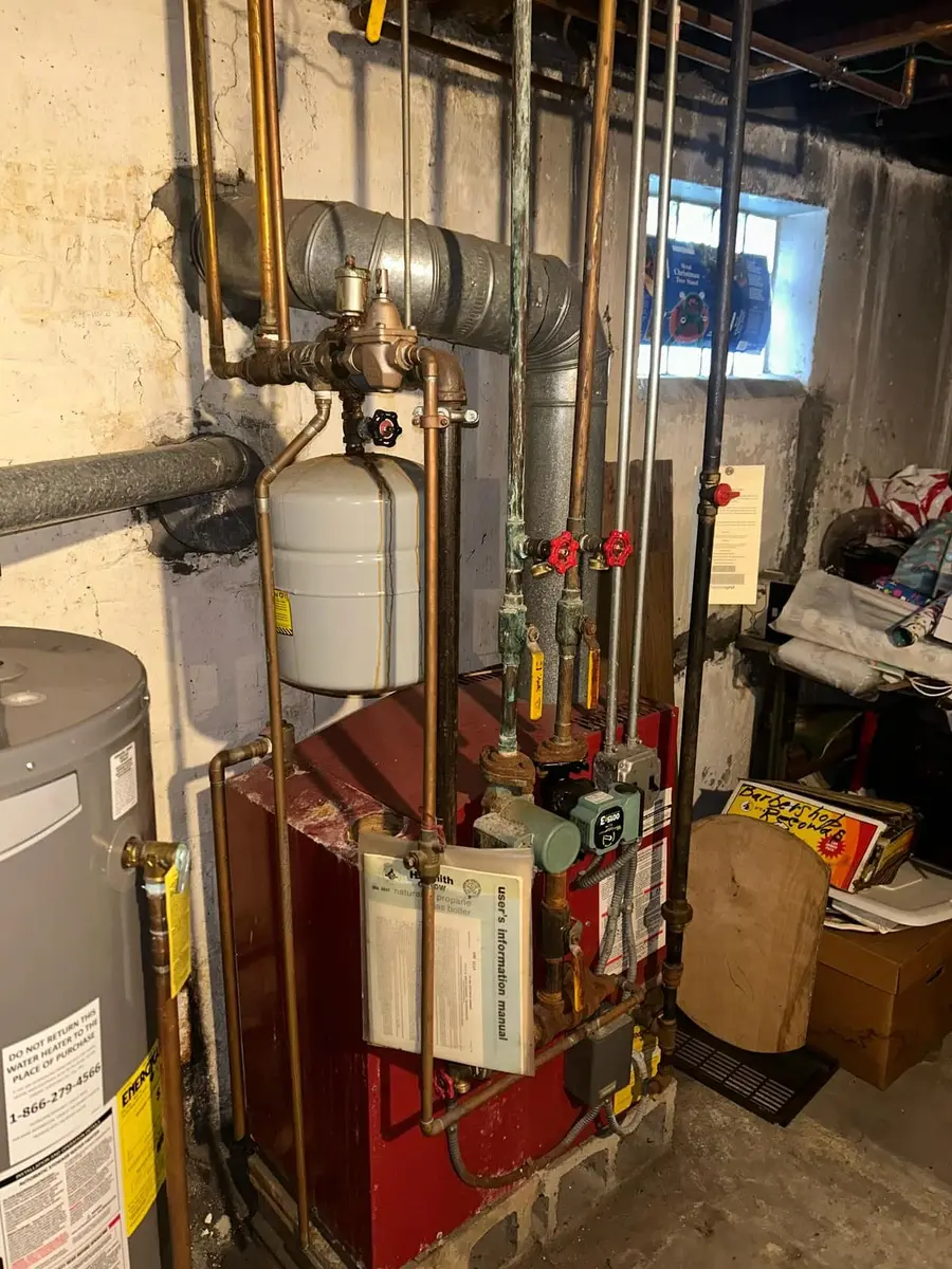 Old red boiler and piping before the replacement