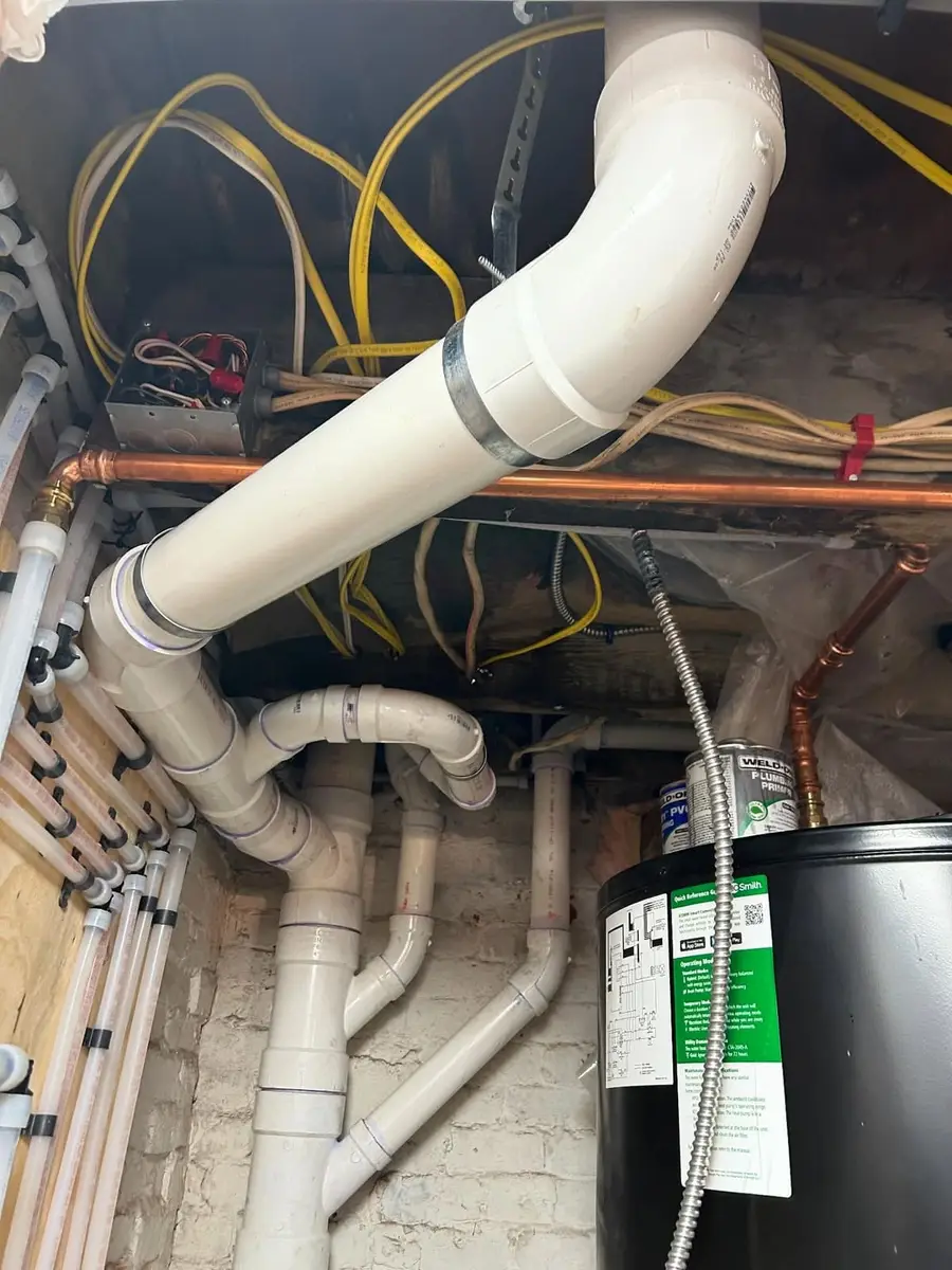 New PVC drain and vent piping above the manifold