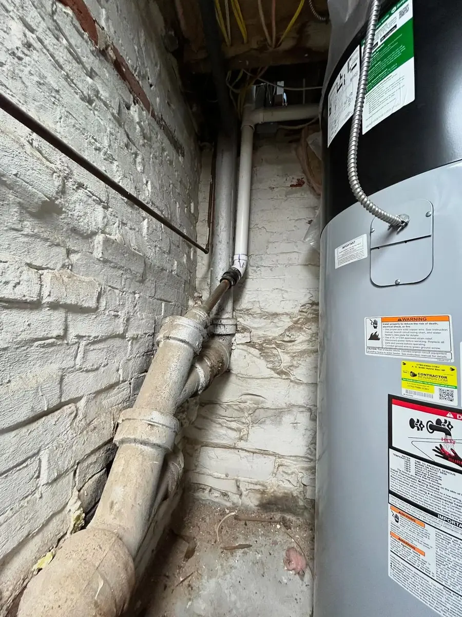 New water heater and drain line in a narrow Saugus basement run