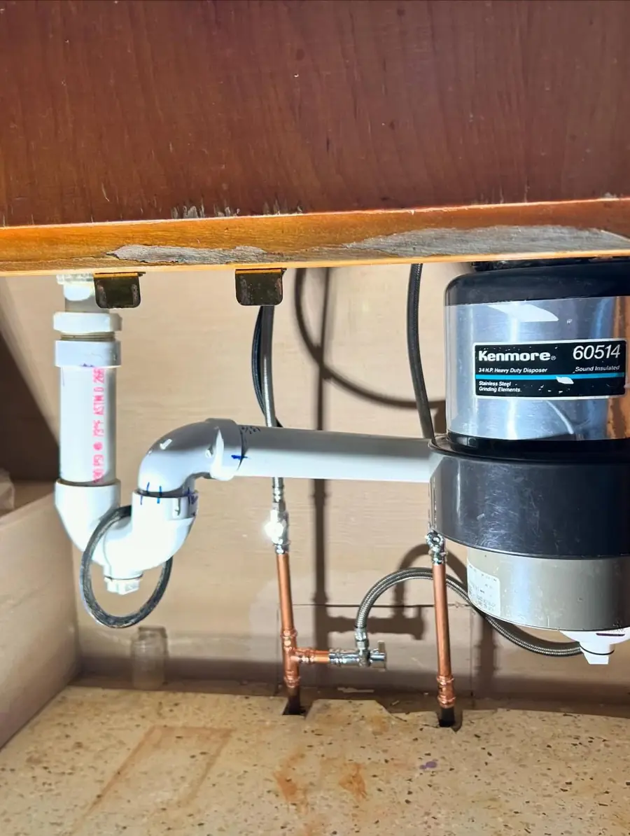 Reworked piping under a kitchen sink