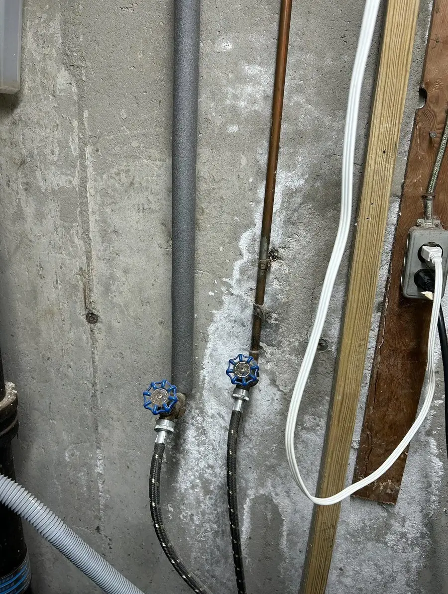 Single-handle laundry valves on the basement wall