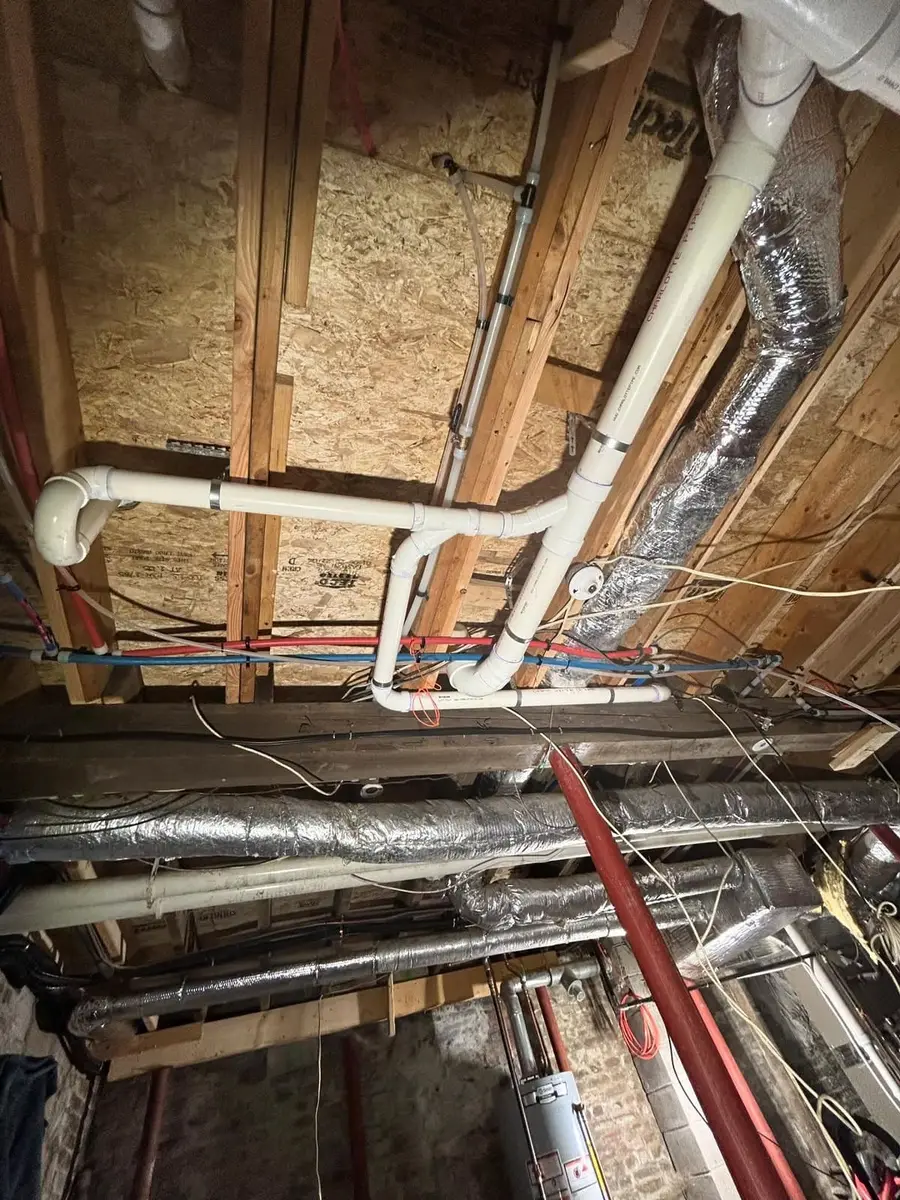 Waste and vent piping run in front of the framing